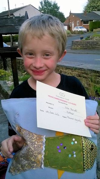 Ellis Burnett with his work and certificate